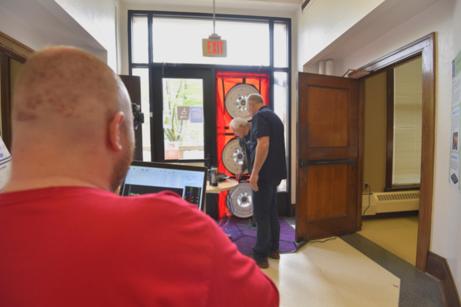 F&S academic collaboration at work. F&S workers here help install of blower doors to measure the effectiveness of the Transportation Building envelope.