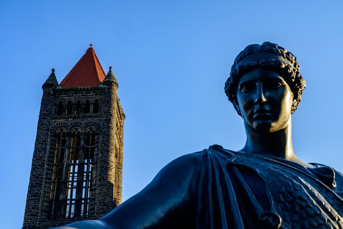 Altgeld Hall graces the skyline, flanked by one of the two figures that stand beside Alma Mater represent "Learning" and "Labor" after the university's motto "Learning and Labor.Ó