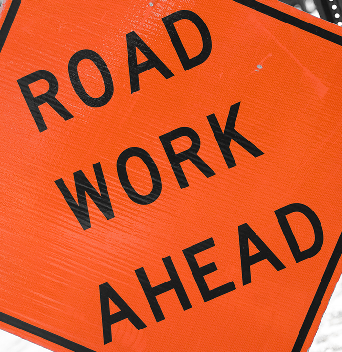 Orange, diamond road work sign