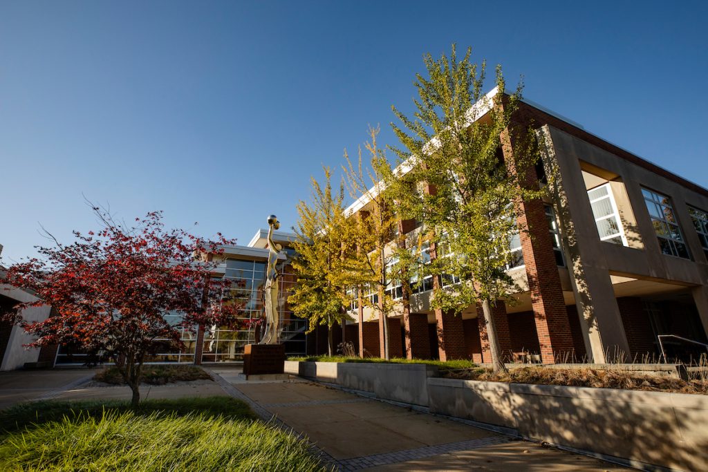 Exterior of the Law Building shows a entryway and trees to the right side.
