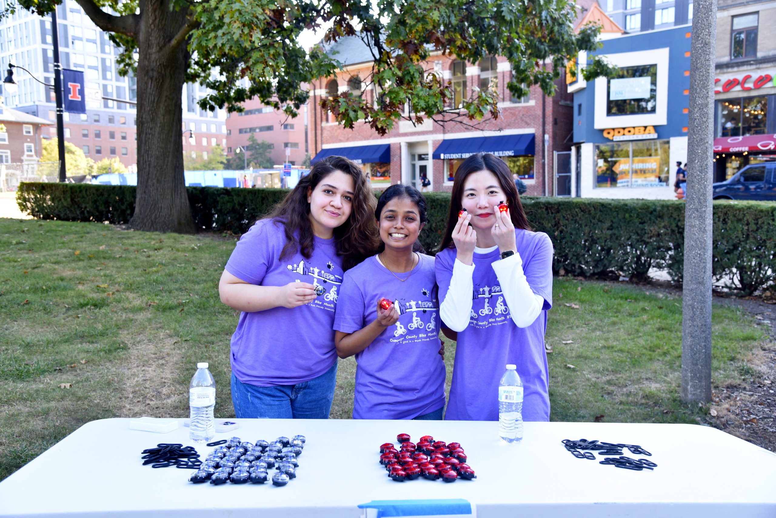 Volunteers hold bike lights at 2024 public event Light the Night.