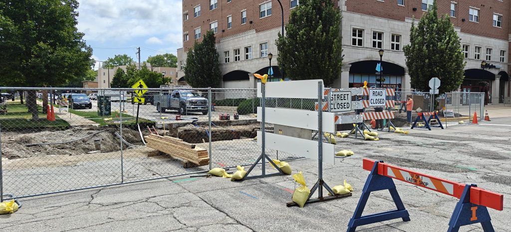 Road closure barriers outline the work perimeter for steam tunnel upgrade work at the intersection of Oregon Street and Gregory Street