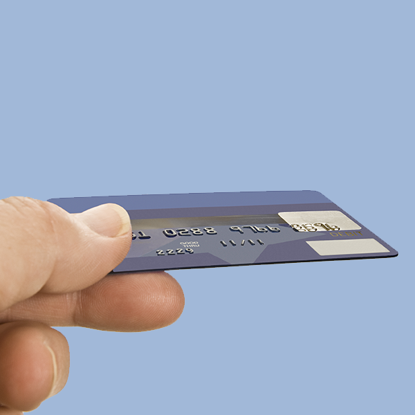 Hand holding a generic fuel cards for swiping at a point of sale station.