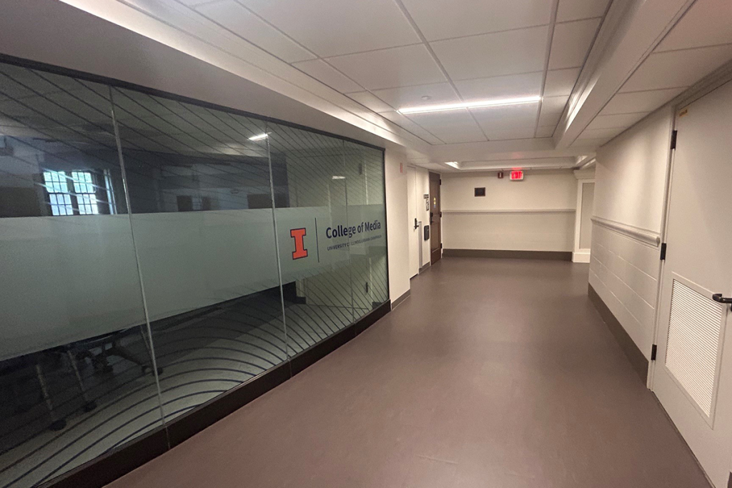 A College of Media room with a glass wall shown in the basement of Gregory Hall.