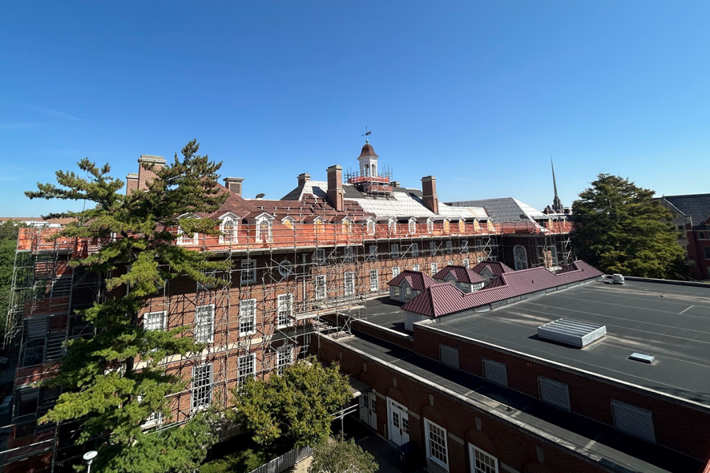 The Illini Union's central and south roofs shown. The south roof is undergoing title work and features a comprehensive scaffolding setup to support the work.