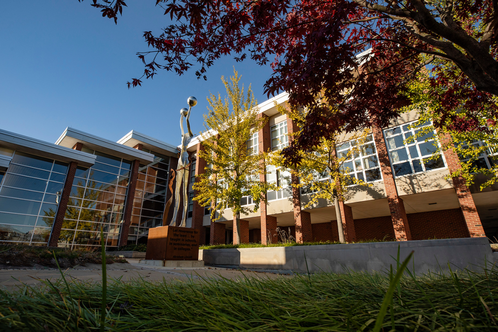 Courtyard in front of the Law Building shown with artwork and landscaping.