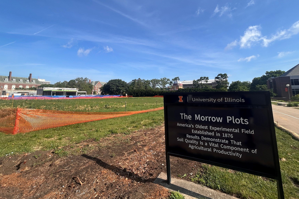 The Morrow Plots shown with orange barrier fencing around the perimeter. The U. of I. location shing is in the foreground to the right.