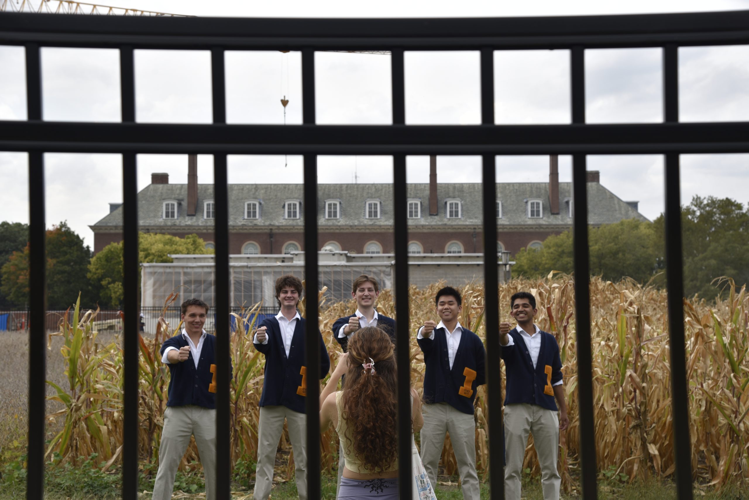 The Other Guys in front of the corn plantings at the Morrow Plots inside fence installed by ironworkers